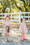 A little girl wearing the Smocked Cowgirl Toile Annabelle Bloomer Set enjoys the soft, breathable cotton, keeping her comfortable all day long.