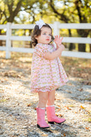 A little girl wearing the Smocked Cowgirl Toile Annabelle Bloomer Set will love the playful yet refined style with its charming cowgirl motifs.