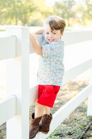 The blue background of the shirt, paired with the cowboy toile print, creates a perfect blend of rustic charm and fun fashion.