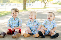 A toddler boy wearing the Blue Cowboy Toile Pima Harold Romper is sure to stand out with its unique and fun cowboy toile design.