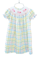 The Smocked Easter Bunnies Dress features hand-smocked pink bunnies with cotton tails, adding a charming and playful touch to any spring occasion.