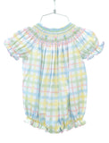 The little girl is wearing the Pastel Smocked Easter Plaid Bubble, and its soft, pastel colors are perfect for Easter and spring celebrations.