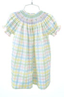 The Pastel Smocked Easter Plaid Dress is made from a soft blend of 65% polyester and 35% cotton, offering both comfort and durability.