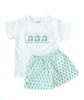 The coordinating shorts, featuring a classic green argyle pattern, complement the green golf cart design for a fun, stylish look.