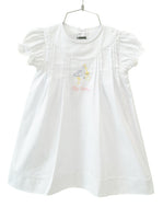 The White Big Sister Stork Dress is a timeless choice for celebrating a special milestone.