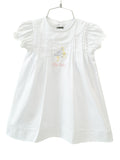 The White Big Sister Stork Dress is a timeless choice for celebrating a special milestone.