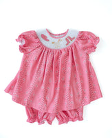 The smocked design ensures a perfect fit, while the pink bandana print brings a pop of color and playful flair.