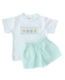 This smocked birthday cake T-shirt with mint green shorts is a festive and timeless outfit for special celebrations.