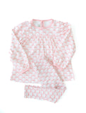 The shirt features a beautiful pink bow pattern, adding a sweet touch to the soft, pastel pink fabric.