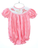 The smocked bubble features intricate smocking with cute boot and bandana details, adding a playful and stylish touch.