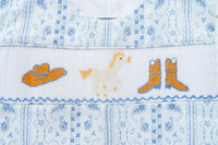 The smocked jonjon is ideal for any casual outing, combining comfort with a fun, western-themed look.