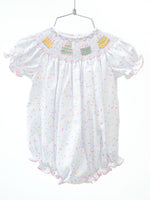 The smocked sprinkle birthday cake bubble is a timeless, heirloom piece designed for unforgettable birthday memories.