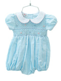 The Classic Blue Smocked Bubble for girls features a hand-smocked bodice with light blue and pink flowers.