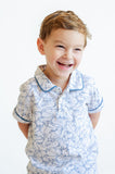 The Playful Bunnies Pima Shep Polo for toddlers and young boys features a fun bunny print with white bunnies outlined in blue, complete with blue piping.