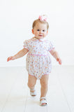 A toddler girl in the Puppies Pima Bubble for girls is ready for playtime, looking cute and cozy in this charming outfit.