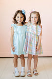 A little girl wearing the Blue Striped Dress will love the sweet ruffle details that add a playful touch.