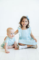 A toddler boy wearing the Blue Striped Bubble with a Peter Pan collar is ready for Easter celebrations with its timeless and charming design.