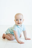 A little boy enjoys a day at the park in the Blue Striped Bubble with a Peter Pan collar, looking both sweet and stylish.