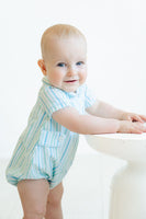 A little baby boy looks absolutely adorable in the Blue Striped Bubble with a Peter Pan collar, perfect for a sunny spring day.