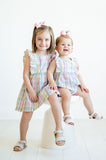 With its bright, cheerful plaid and ruffle details, a baby girl in the Colorful Plaid Bubble is the picture of springtime cuteness.