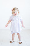 A little girl shines brightly in this delightful bloomer set, designed for comfort and style on her big day.