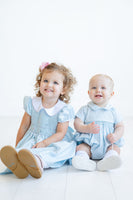 The Classic Blue Smocked Arthur Bubble is available in sizes NB to 2T, ensuring a perfect fit for little ones.