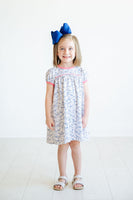 The Playful Bunnies Pima Catherine Dress is available in sizes 12M to 8, making it ideal for toddlers and young girls.