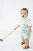 A little boy in the Smocked Green Golf JonJon is ready for The Masters, capturing the spirit of the game in style.