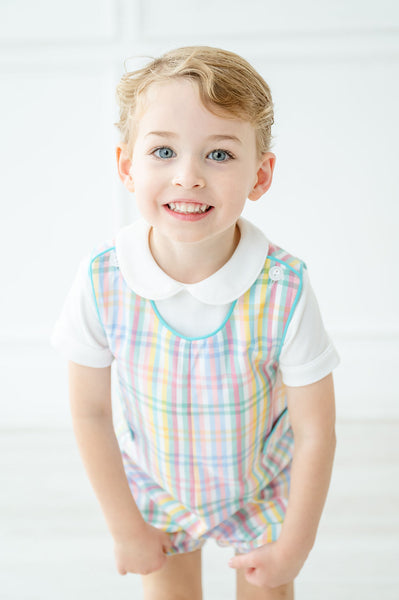 A little boy wearing the Colorful Plaid JonJon looks charming in its vibrant plaid pattern, perfect for spring celebrations.