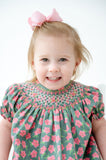 A little girl wearing the pink and green smocked bloomer set looks radiant at any spring celebration.