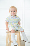 The Pastel Smocked Easter Plaid Shirt and Short Set is available in sizes 12M to 6, offering a great fit for toddlers and young boys.