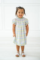 The Pastel Smocked Easter Plaid Dress is available in sizes 12M to 8, making it a versatile option for young girls.