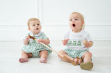 A toddler boy in the Green Smocked T-Shirt and Short Set is ready for golf outings, the Masters, or any fun springtime event with friends.