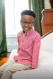 little boy wearing red gingham long sleeve button up shirt.