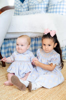 boy and girl wearing smocked candy corn outfits