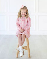 Girl wearing smocked pink floral dress