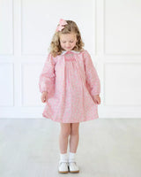 Girl wearing smocked pink floral dress