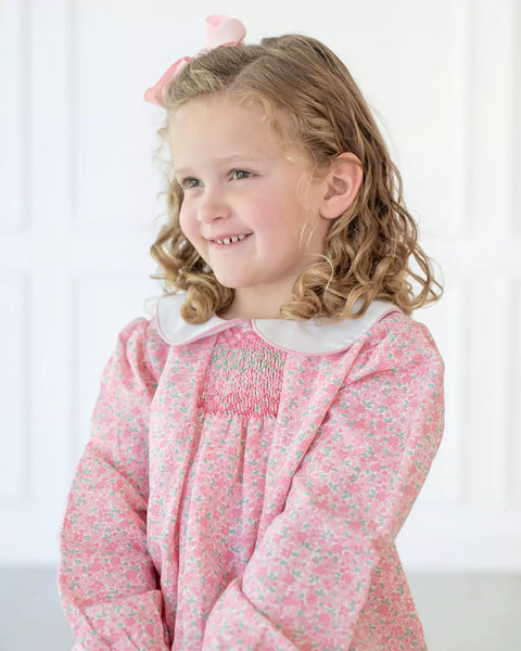 Girl wearing smocked pink floral dress