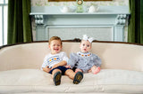 boy and girl wearing smocked pumpkin outfits