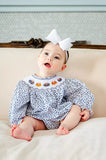 girl wearing smocked floral and pumpkins bubble