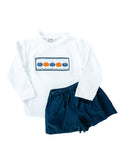 Flat lay of  smocked pumpkin t-shirt and shorts