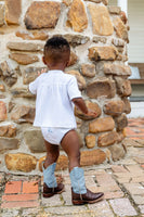 Toddler boy wearing hand embroidered blue cowboy boots layette set and boots.