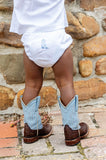 Toddler boy wearing hand embroidered blue cowboy boots layette set and boots.