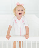 Toddler girl wearing pink hand embroidered cowgirl boots layette set.