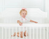 Toddler girl wearing pink hand embroidered cowgirl boots layette set.